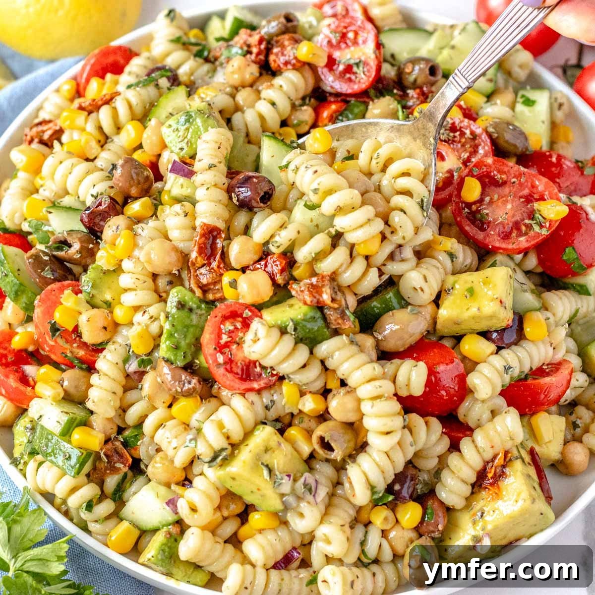 Beat the Heat 30 No-Bake Dinners 8 Easy and vibrant chickpea pasta salad with cherry tomatoes and olives, perfect for a cold summer dinner.
