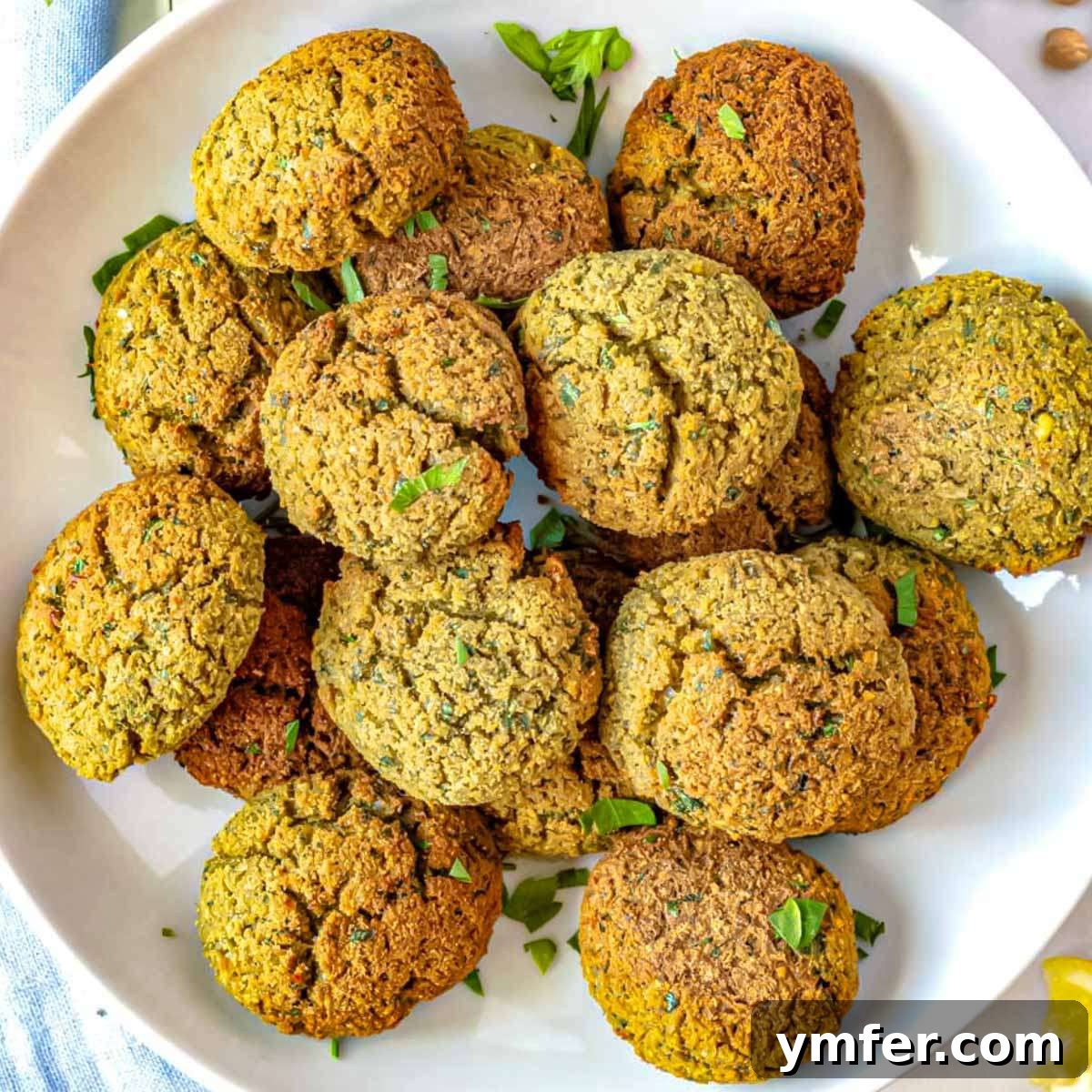 30 Delectable Picnic Recipes 13 A stack of golden brown homemade falafel on a plate, ready to be served.