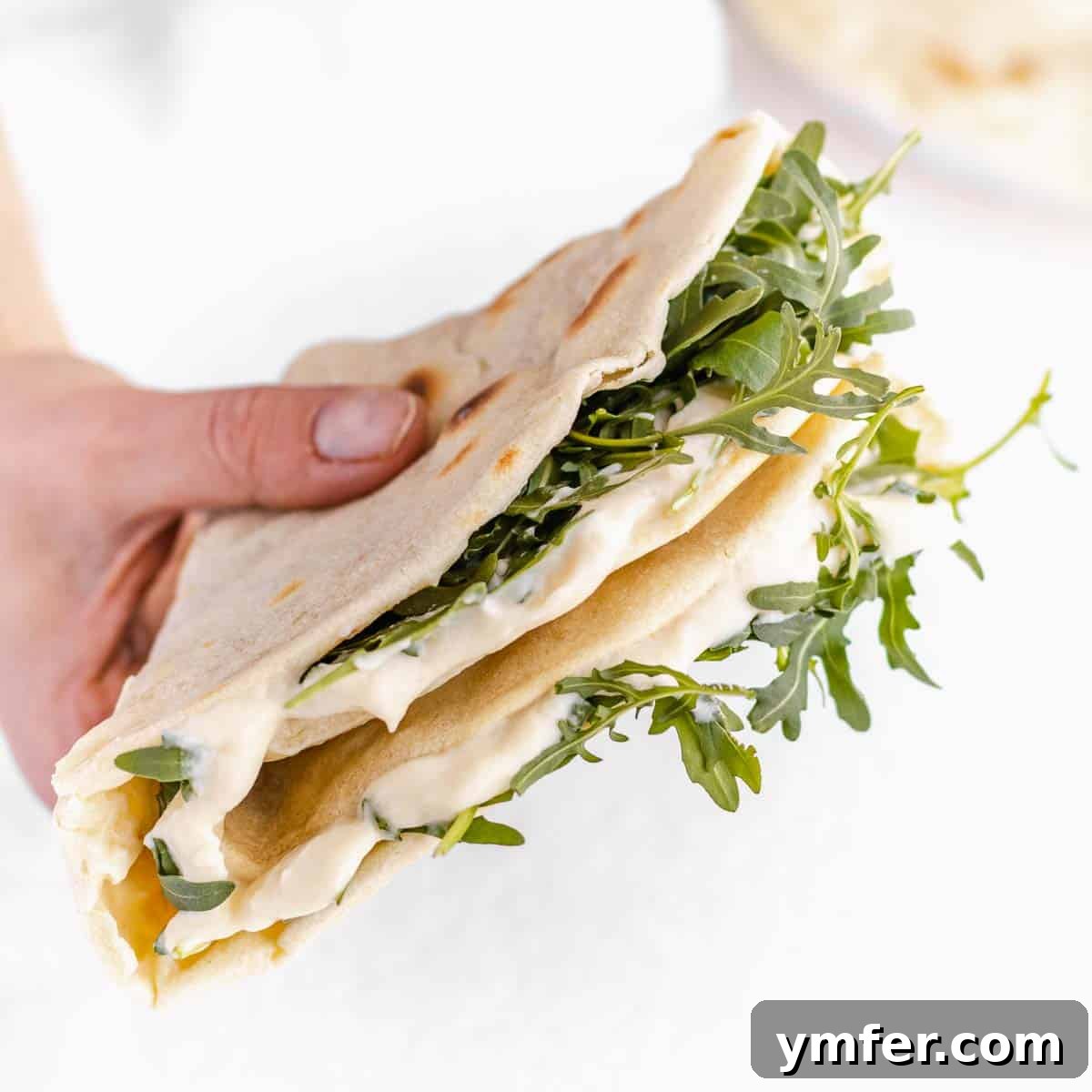 30 Delectable Picnic Recipes 8 A serving of piadina, a traditional Italian flatbread, filled with vegan melted cheese and fresh arugula.