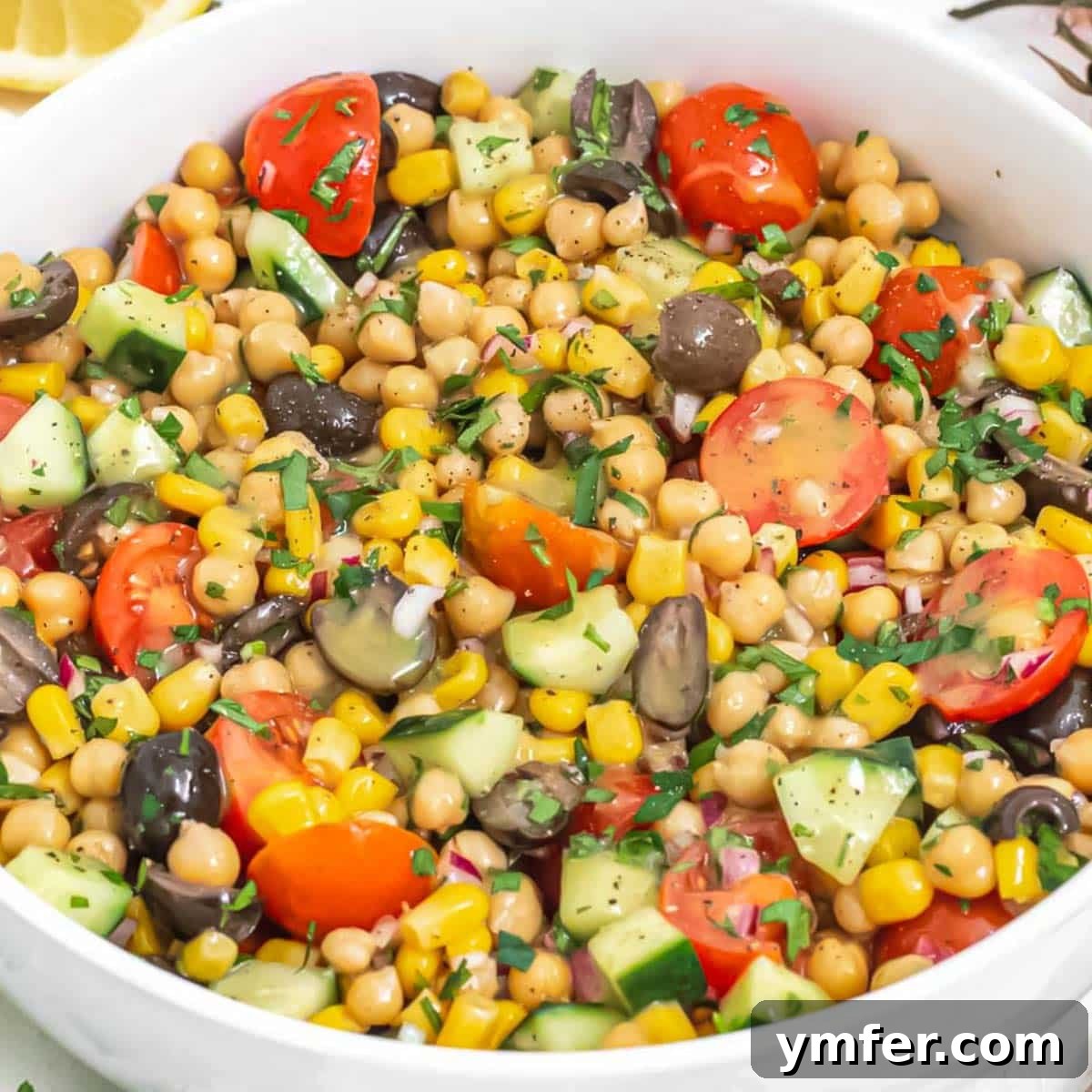 Mediterranean Diet for Vibrant Health 4 A vibrant and nutritious chickpea salad with fresh herbs, colorful diced vegetables, and a light zesty dressing, served in a rustic bowl.