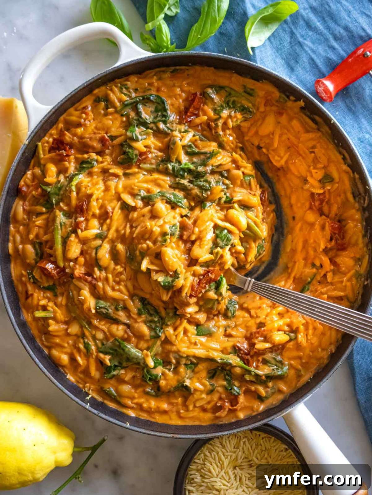 Say Yes To This Orzo 2 Creamy Marry Me Orzo served in a skillet with a fresh lemon wedge, ready to be enjoyed.