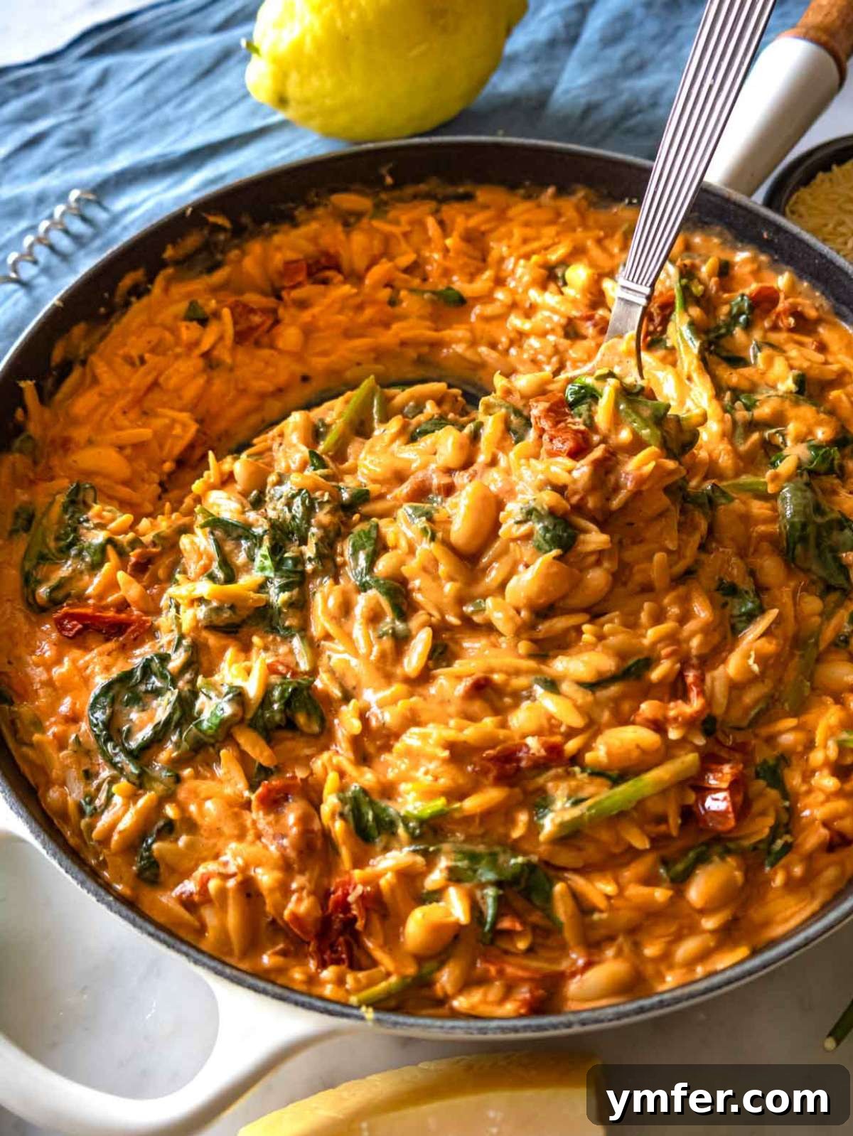 Say Yes To This Orzo 3 Close-up of a perfectly creamy Marry Me Orzo dish, showcasing sun-dried tomatoes, spinach, and a rich, golden sauce.