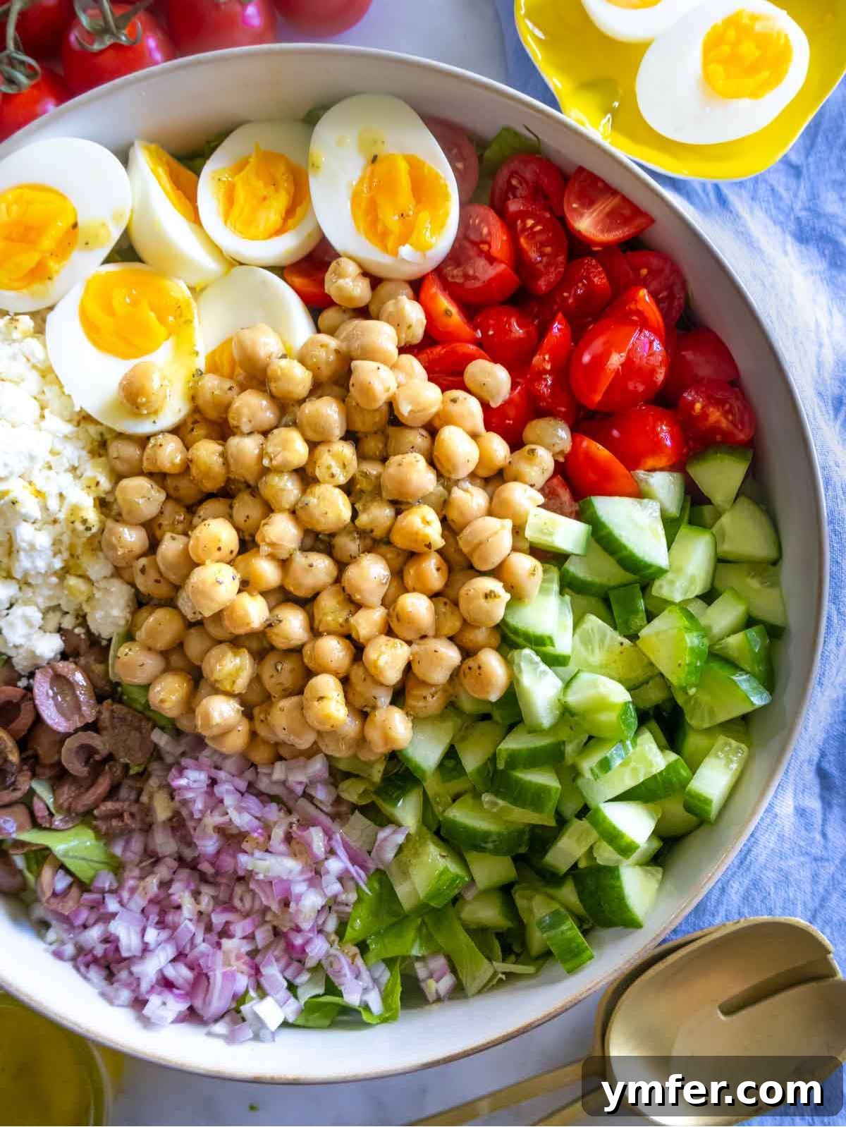 Vibrant Mediterranean Bowl 2 Vibrant Mediterranean chopped salad served in a bowl with an assortment of fresh vegetables and boiled eggs, highlighting its freshness and appeal.