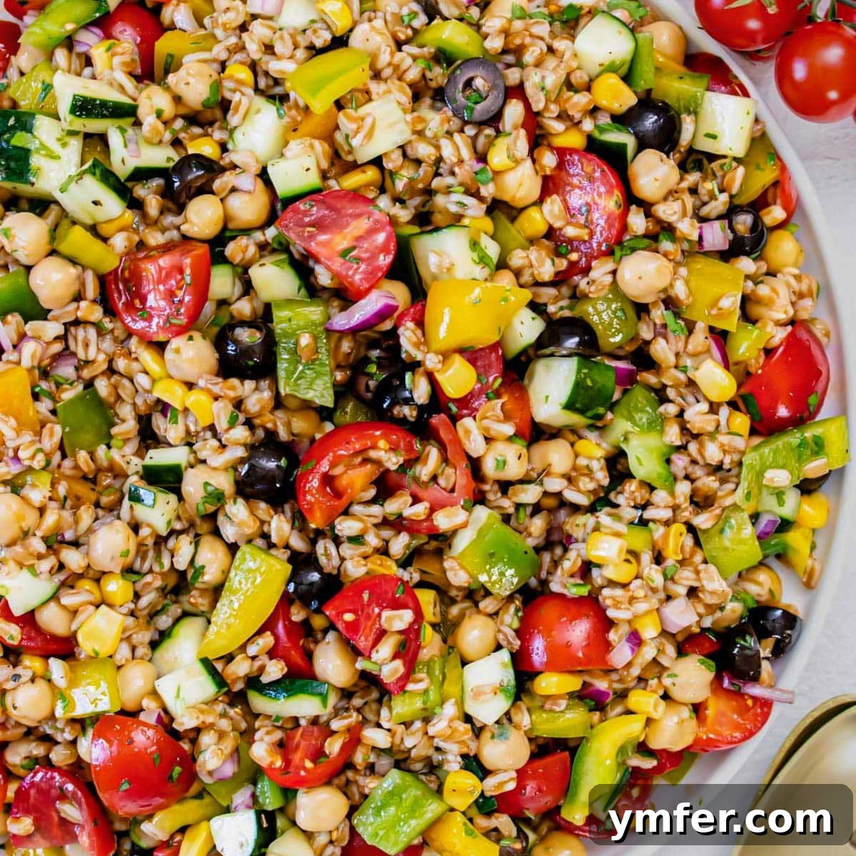 9 Mediterranean Proteins to Power Your Plate 15 A close-up of a refreshing farro salad, mixed with chickpeas, tomatoes, and herbs.