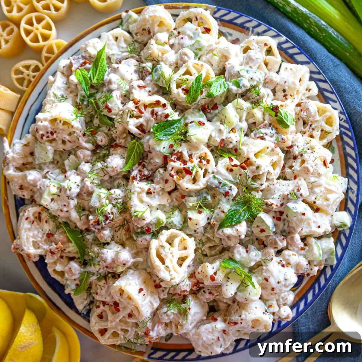 9 Mediterranean Proteins to Power Your Plate 24 A colorful cold pasta salad, presented in a bowl with fresh herbs, ideal for summer gatherings and lunches.