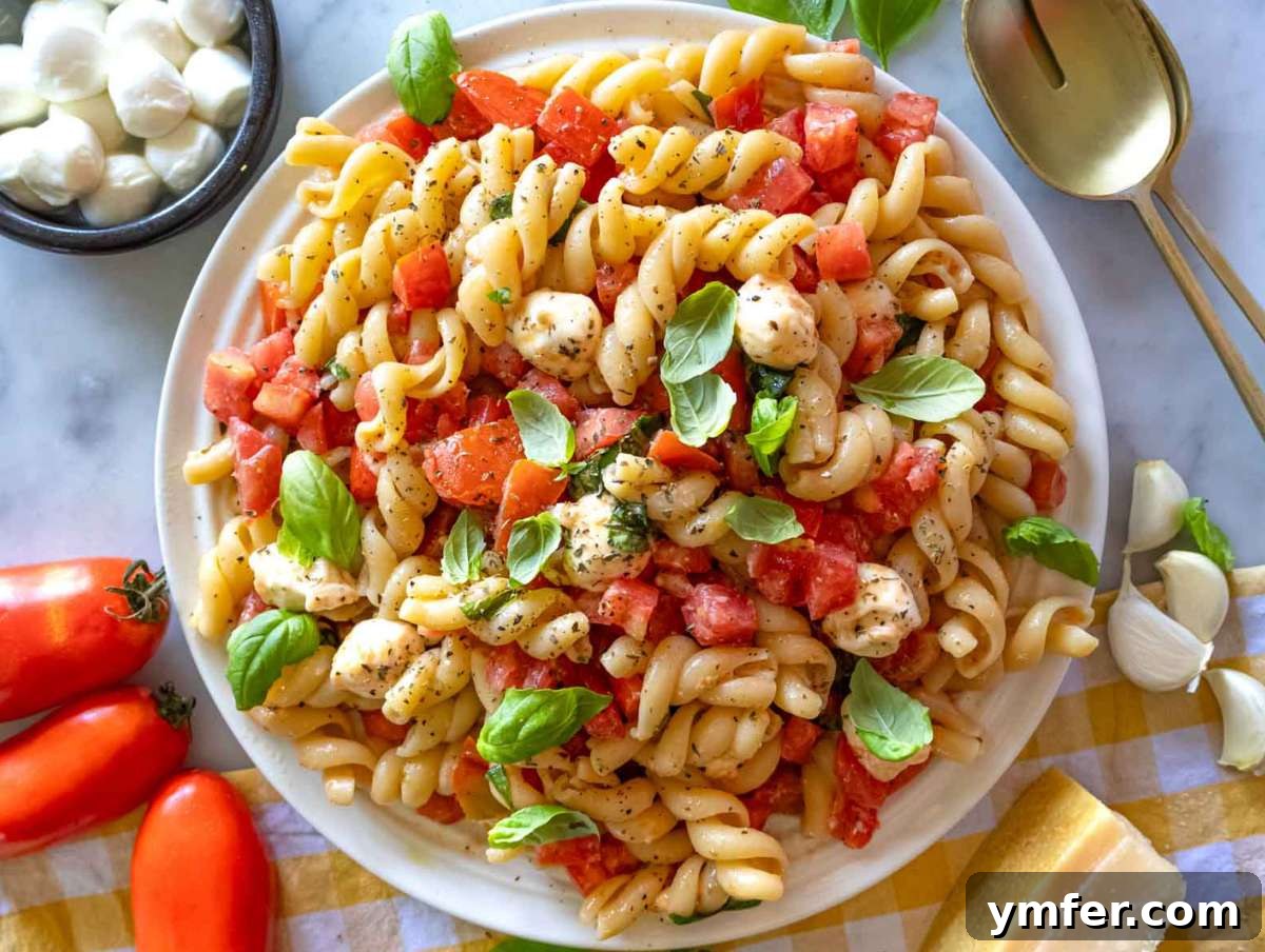 Easy Bruschetta Pasta No Cook Sauce 7 Step 3: Hot pasta being enthusiastically tossed with the fresh tomato bruschetta mixture in a large bowl, ensuring every piece is coated.