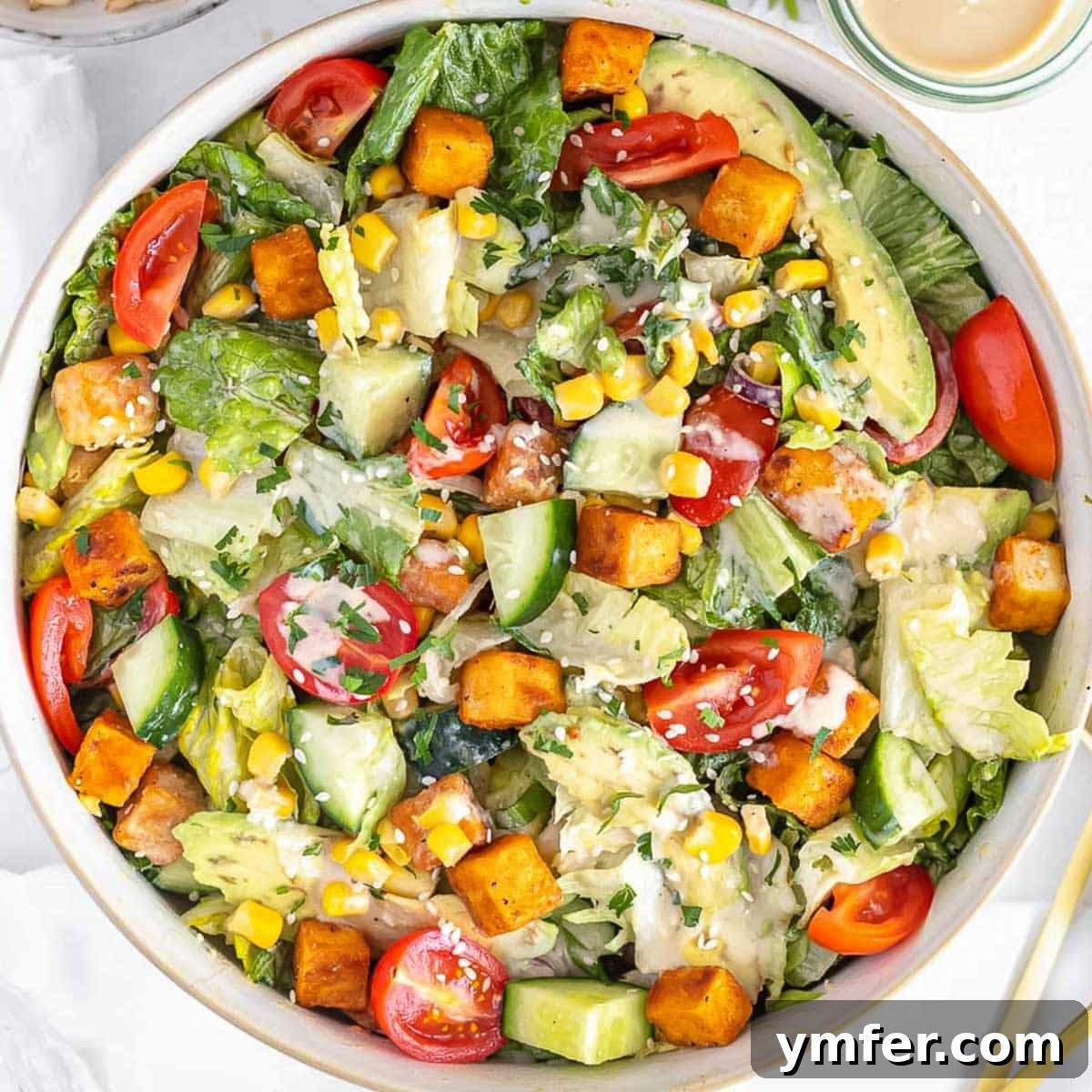 Strong & Satisfying: 21 High-Protein Salad Recipes 16 Tofu salad with tahini sauce in a bowl.
