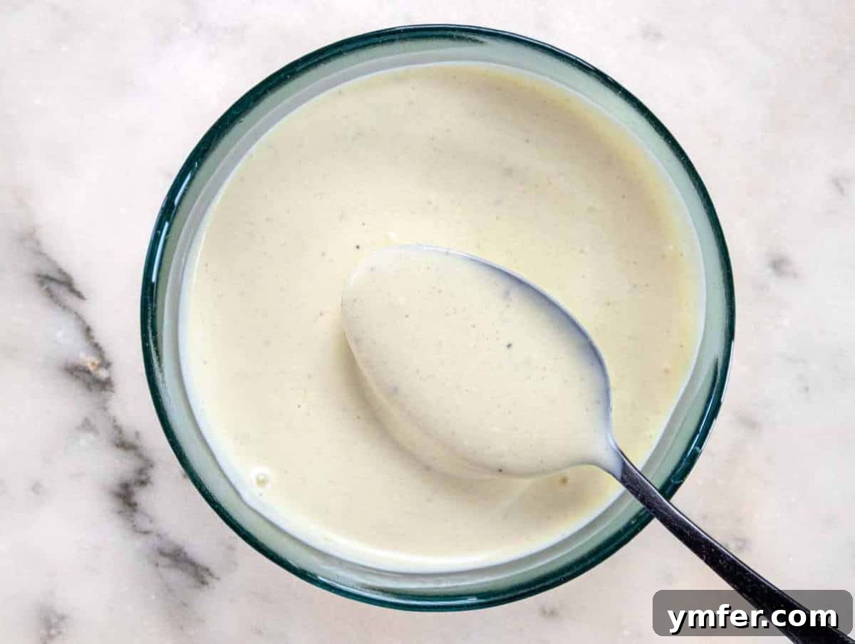 Wholesome & Creamy Greek Yogurt Coleslaw 7 Step 3: Vigorously whisking together the creamy Greek yogurt dressing in a small bowl, combining tangy mustard, apple cider vinegar, and a touch of mayonnaise for a perfectly smooth consistency.