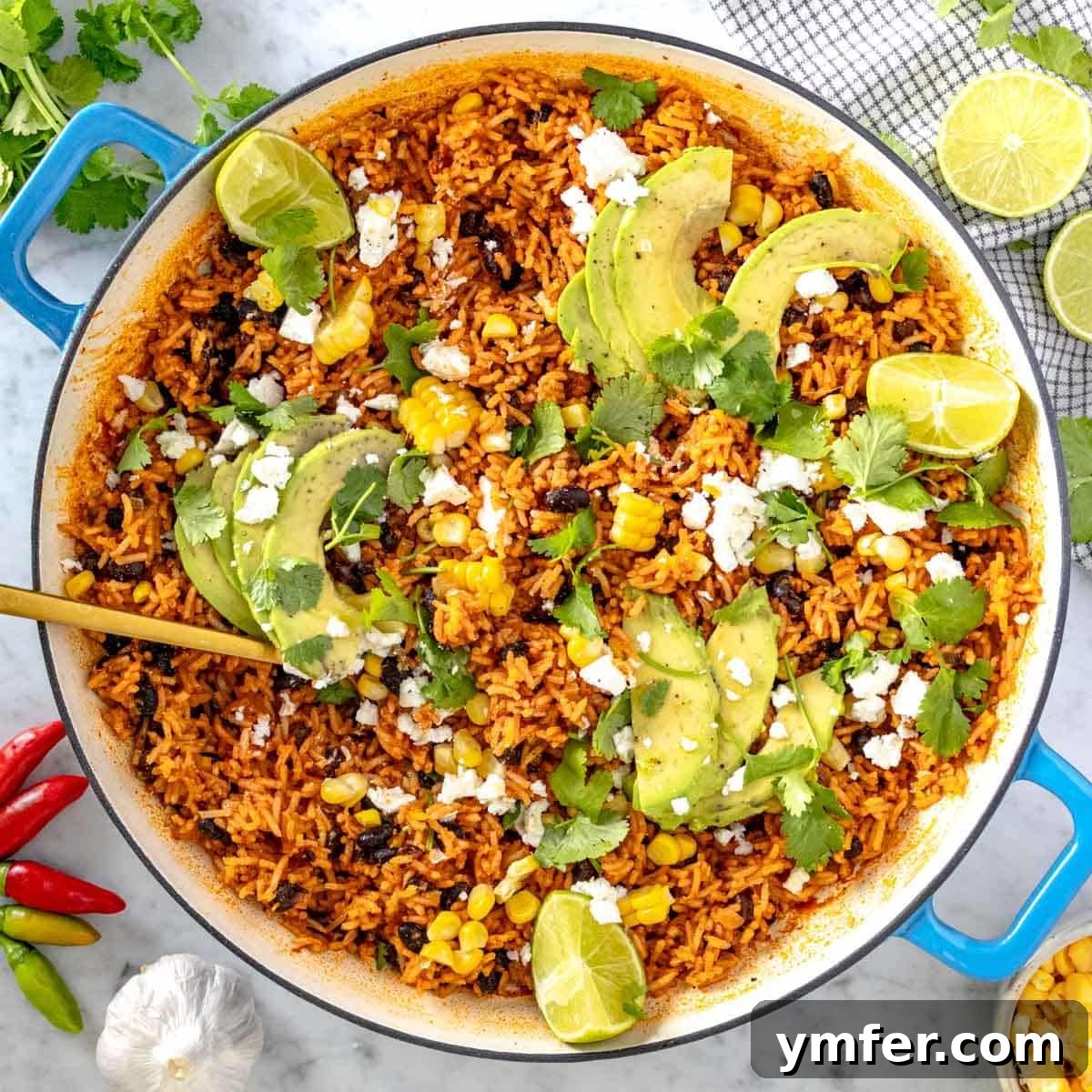 19 Simple Bean Recipes to Slash Your Weekly Food Bill 12 Mexican rice with creamy avocado slices and fresh cilantro in a skillet, showcasing a vibrant and flavorful one-pot meal.