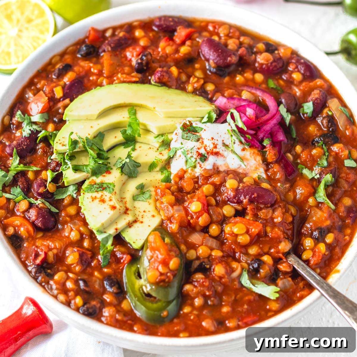19 Simple Bean Recipes to Slash Your Weekly Food Bill 15 Hearty lentil chili topped with creamy avocado and a dollop of sour cream, a satisfying and wholesome meal.