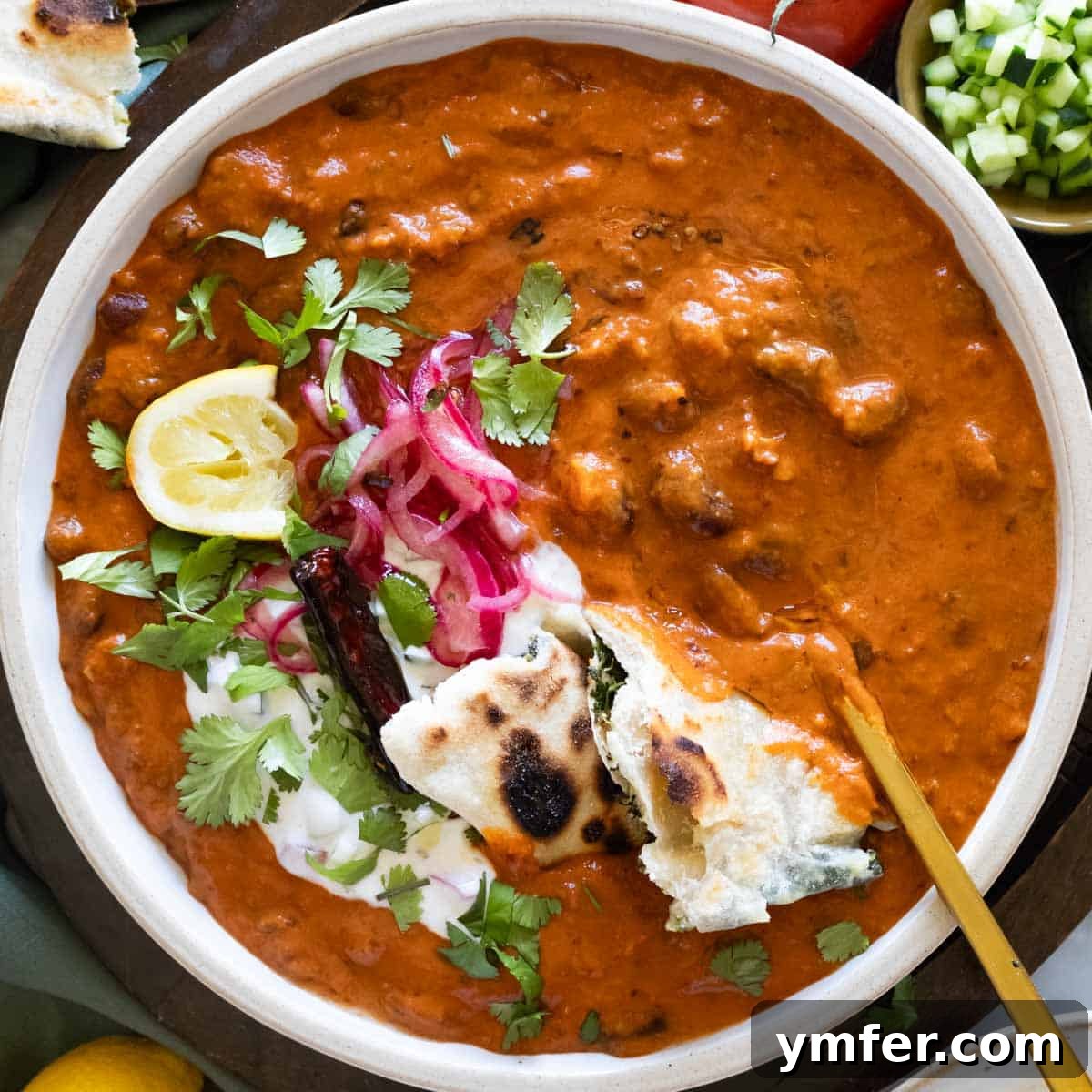 19 Simple Bean Recipes to Slash Your Weekly Food Bill 17 Authentic Indian Rajma (Kidney Bean Curry) with a spoon, highlighting its rich texture and vibrant colors.