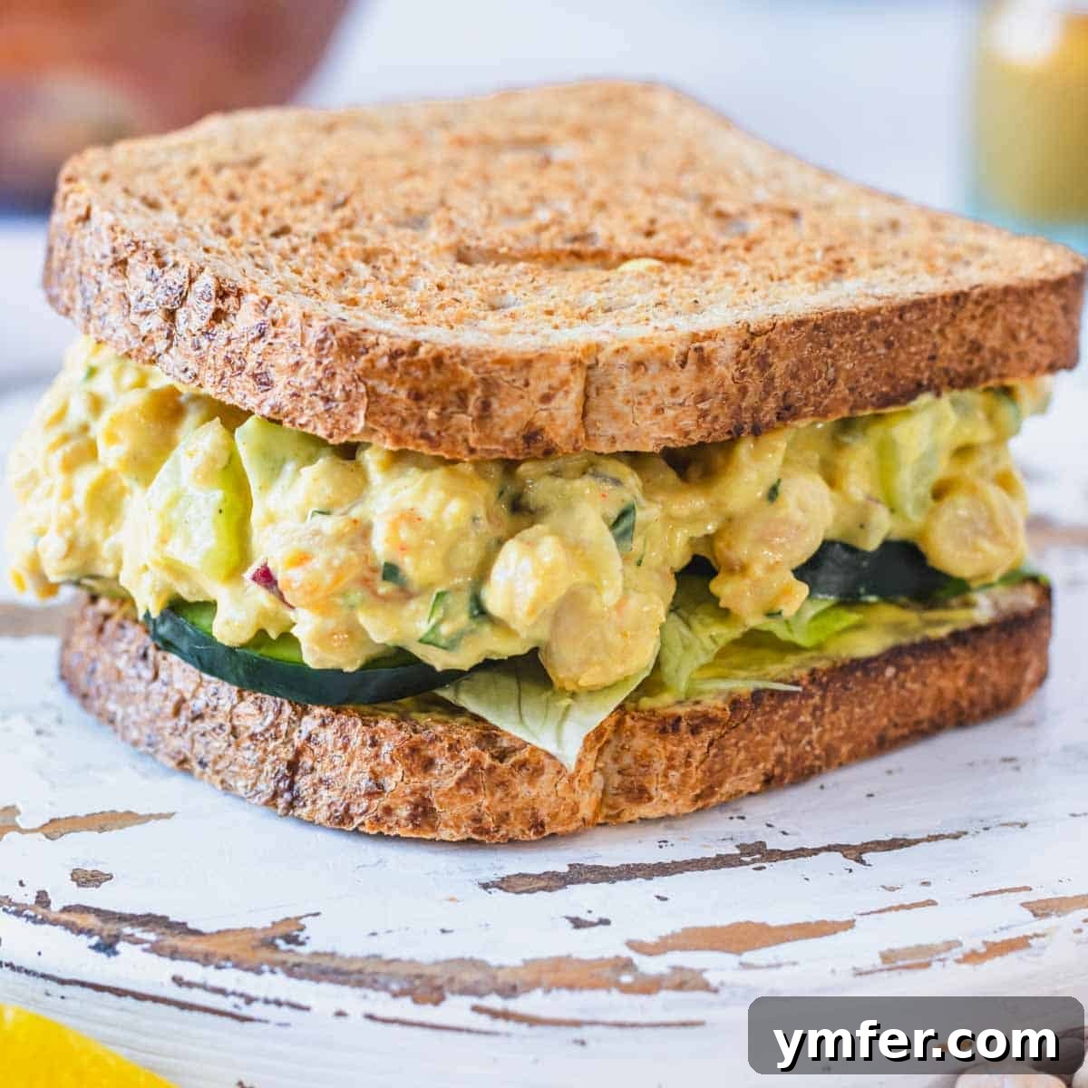 19 Brilliant Greek Yogurt Recipes for Lunch Dinner and Dessert 5 Curry chickpea salad served in a sandwich with fresh cucumber slices, a high-protein Greek yogurt recipe.
