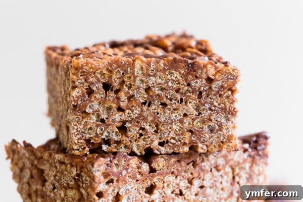 Nutella Peanut Butter Krispie Dream Bars 3 Peanut Butter Nutella Rice Krispie Treats sliced to show the sides.
