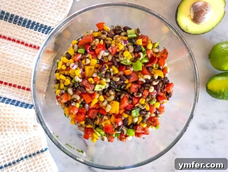 Step 3 Tossing Cowboy Caviar salad and adjusting flavors before chilling in the fridge.