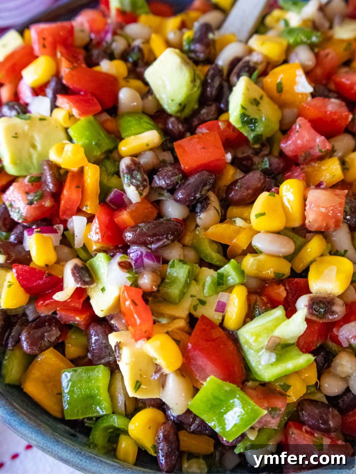 Southwestern Marinated Bean Medley 3 Close up of Cowboy Caviar dip with avocado beans corn and peppers.