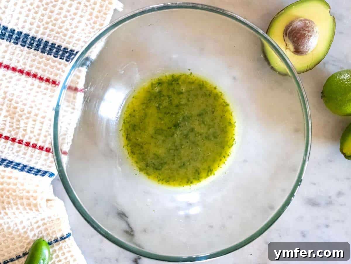 Southwestern Marinated Bean Medley 5 Step 1 Whisking dressing for Cowboy Caviar with olive oil cilantro lime honey and mustard.