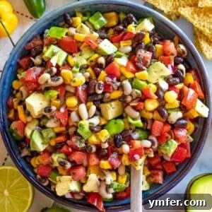 Healthy Cowboy Caviar with black beans corn peppers and avocado in a bowl.