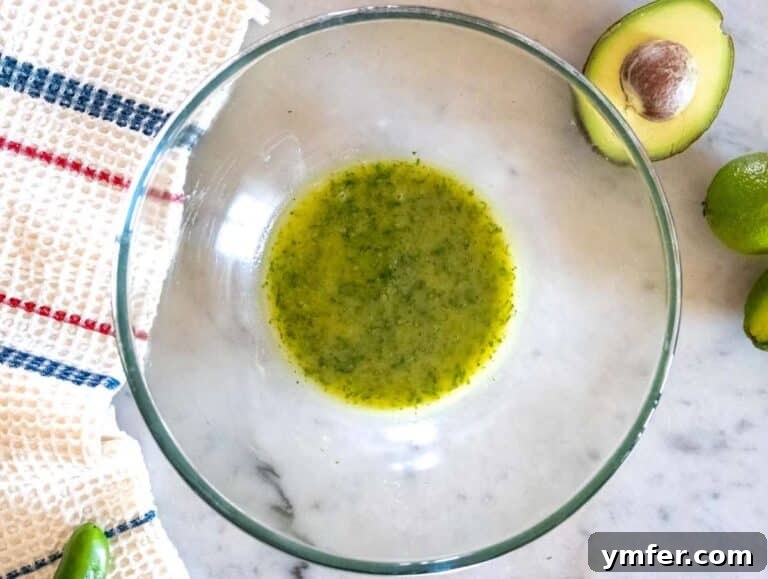 Step 1 Whisking dressing for Cowboy Caviar with olive oil cilantro lime honey and mustard.
