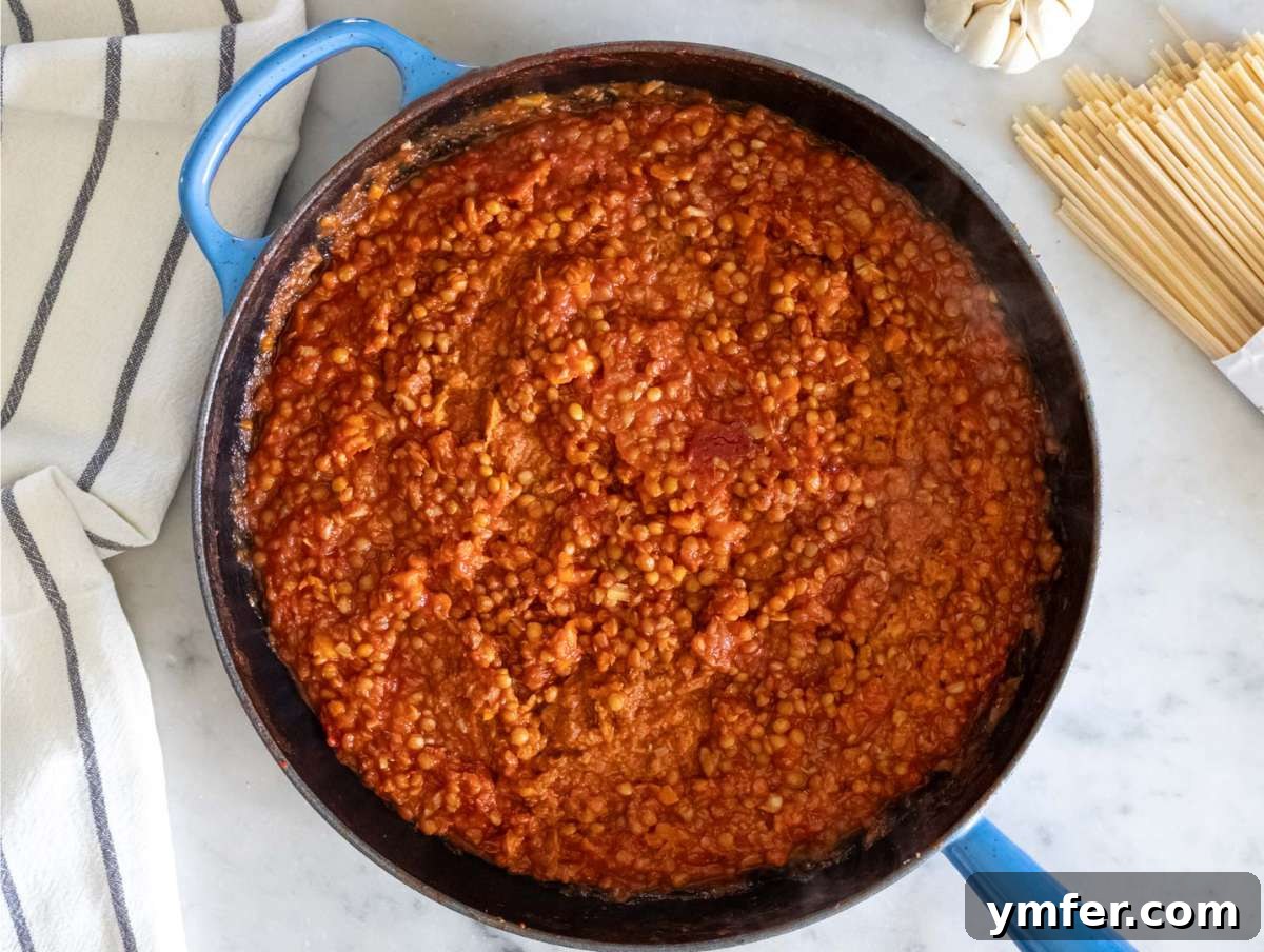 Speedy Lentil Bolognese Dinner in Half an Hour 6 Step 2: Lentils and tomato puree simmering together in one pot, creating the base for the bolognese sauce.
