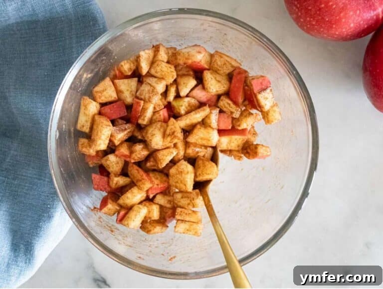 Protein Packed Cinnamon Apple Muffins 11 Step 1 Diced apple mixed with cinnamon sugar in small bowl.