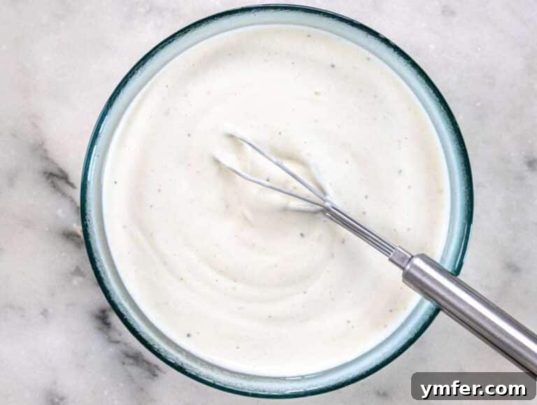 Step 2 Mixing Greek yogurt mayo vinegar and honey in a bowl for salad dressing.