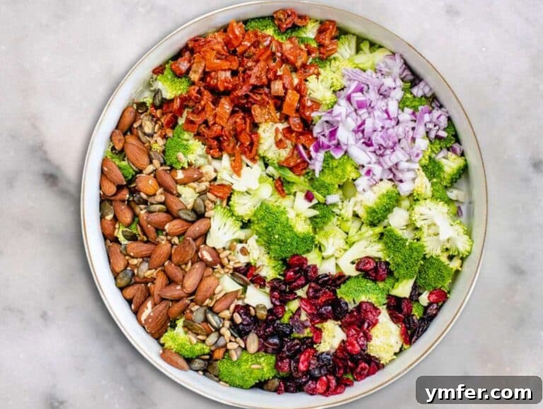 Step 3 Chopped Broccoli nuts cranberries seeds and onion in a large mixing bowl.