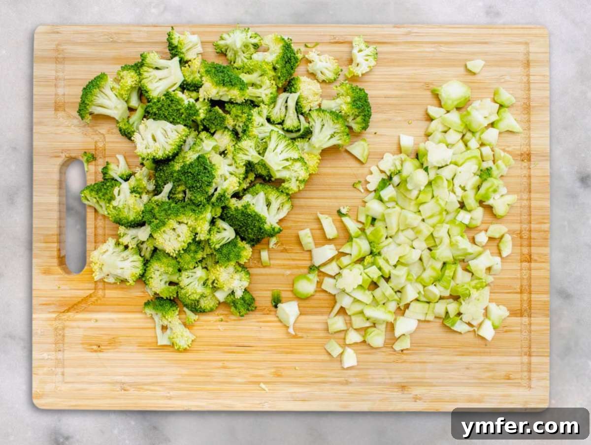 Step 1 Chopped broccoli florets and stems on a cutting board ready for salad.