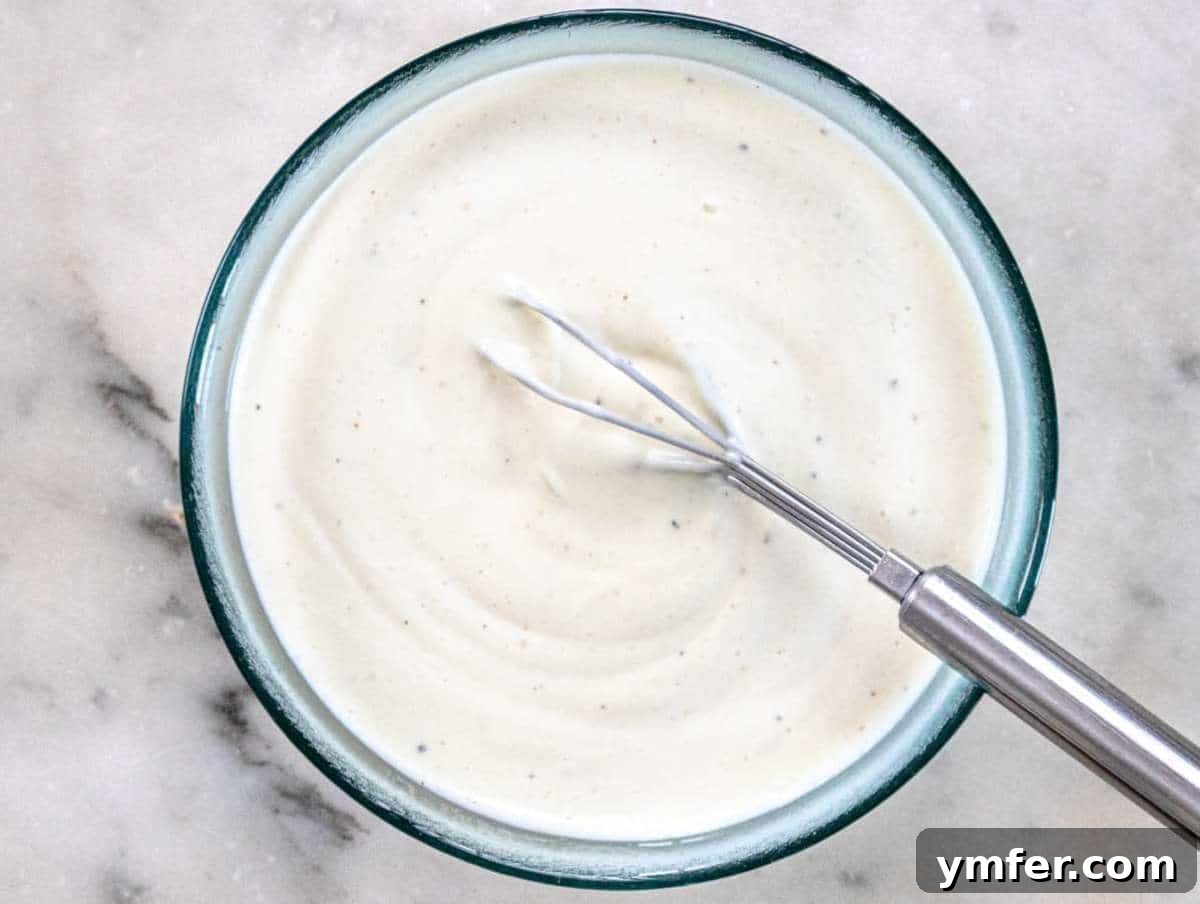 Step 2 Mixing Greek yogurt mayo vinegar and honey in a bowl for salad dressing.