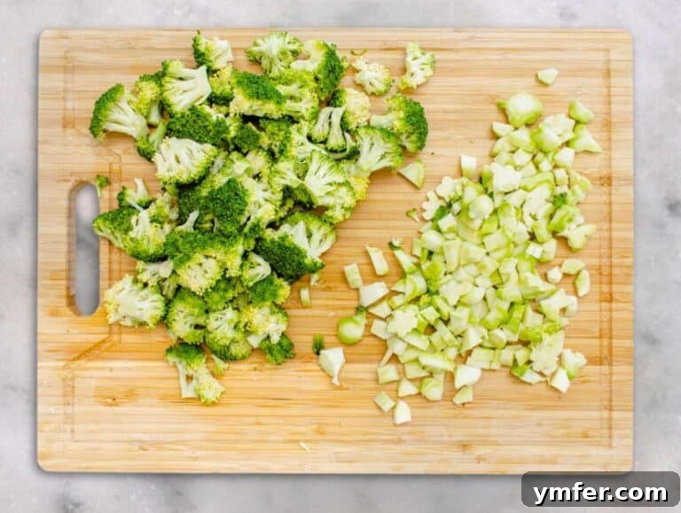 Step 1 Chopped broccoli florets and stems on a cutting board ready for salad.