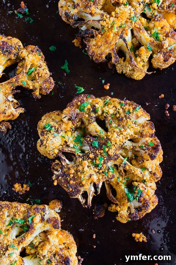 Golden Cajun Parmesan Cauliflower Steaks 2 A vibrant Parmesan Cajun Spiced Cauliflower Steak, beautifully seasoned and topped with fresh parsley, ready to be enjoyed.