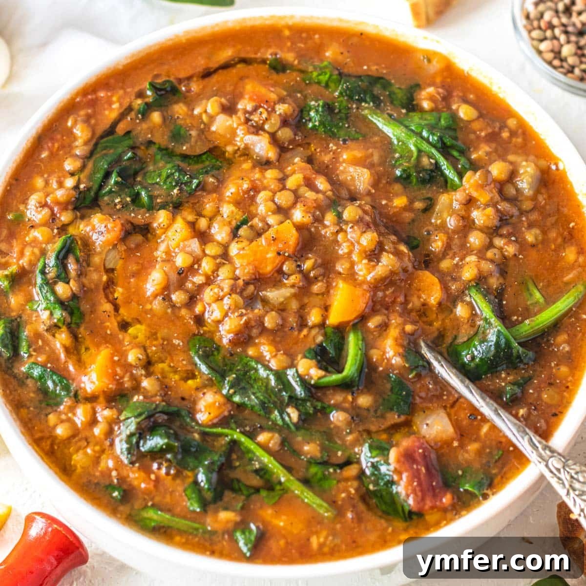 Boost Your Gut: 25+ Fiber-Packed Meals for Digestive Health 12 Lentil vegetable soup with spinach and a silver spoon