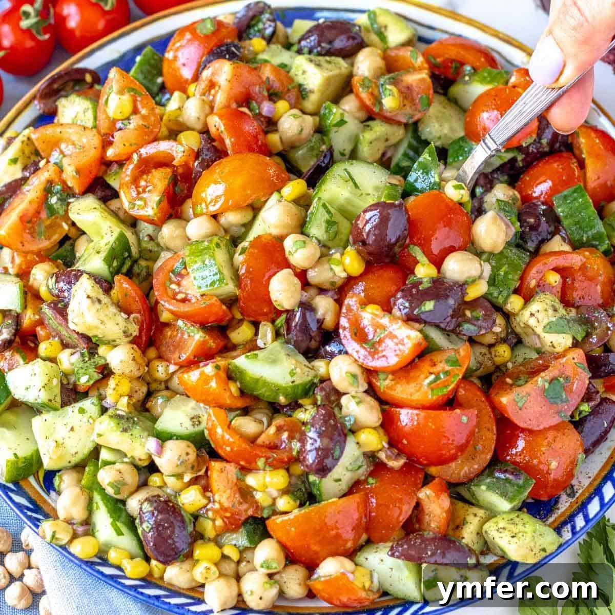 Boost Your Gut: 25+ Fiber-Packed Meals for Digestive Health 4 Chickpea cucumber salad served on a blue platter with avocado and fresh parsley.
