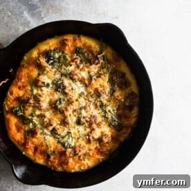 This sausage broccoli rabe skillet pizza is perfectly seasoned and made with 3 different delicious kinds of cheese. It's made right in a 12-inch cast iron skillet and comes out perfectly crisp.