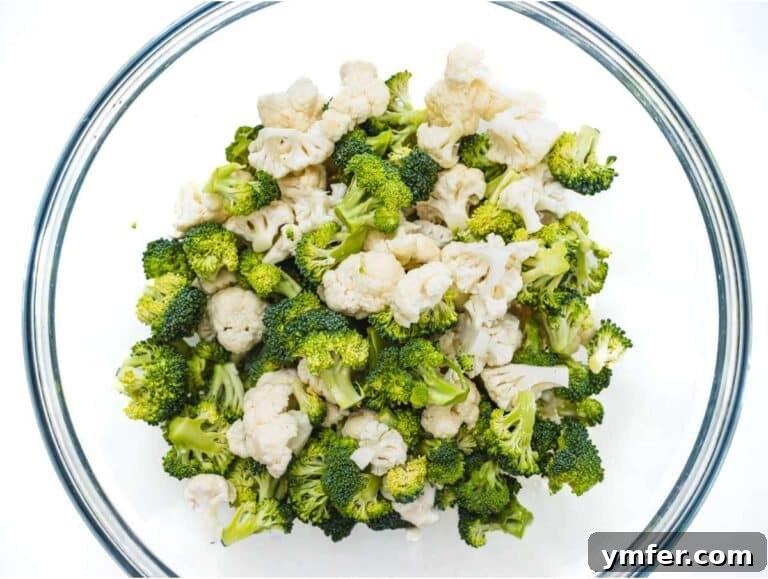 Creamy Broccoli Cauliflower Salad with Tangy Greek Yogurt 11 Step 1 Chopped broccoli and cauliflower florets in mixing bowl for healthy broccoli cauliflower salad.