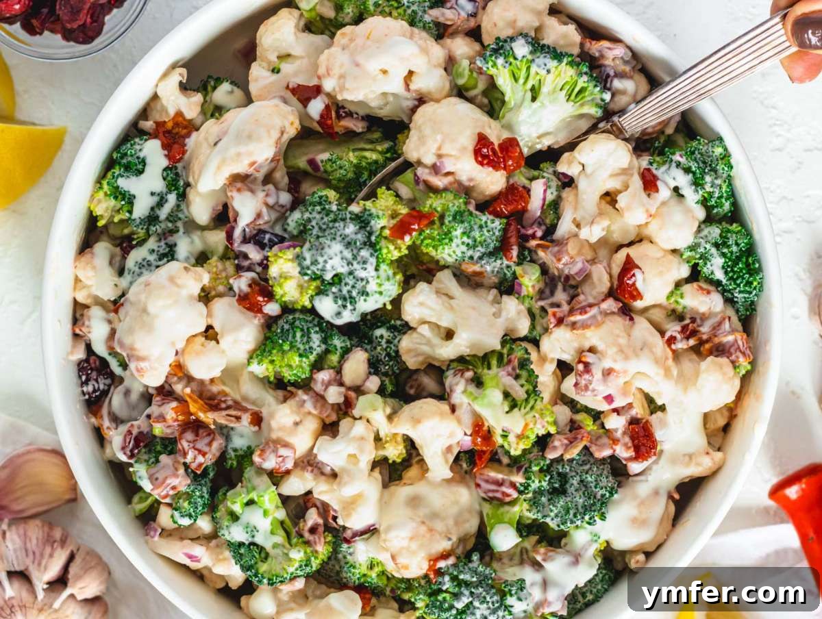 Creamy Broccoli Cauliflower Salad with Tangy Greek Yogurt 8 Step 4 Tossing the healthy broccoli cauliflower salad with creamy Greek yogurt dressing in a large bowl before chilling.
