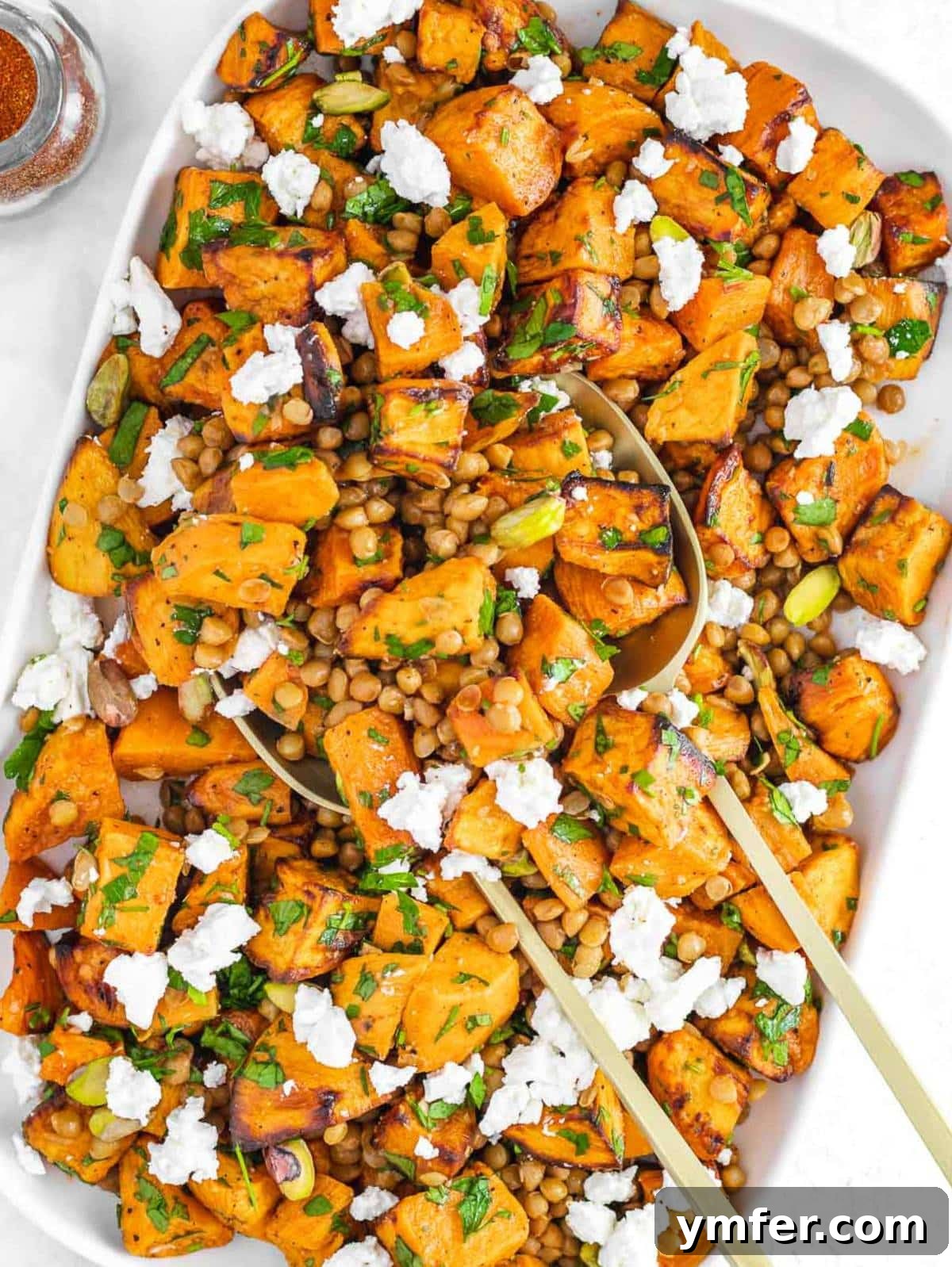 Top down view of healthy lentil sweet potato salad with roasted sweet potatoes and feta.