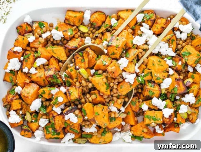 Step 4 Healthy lentil sweet potato salad served on a white platter with parsley garnish.