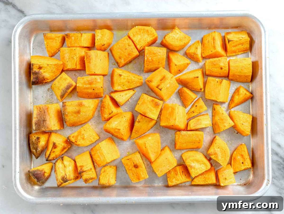 Step 1 Cubed sweet potatoes on baking tray roasted for Mediterranean lentil salad.