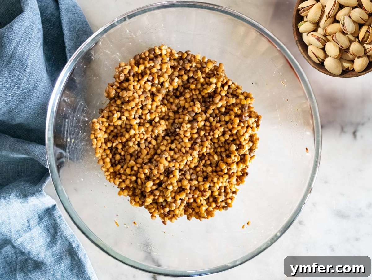 Step 3 marinating lentils in dressing to boost flavor while waiting for the sweet potatoes to cook.