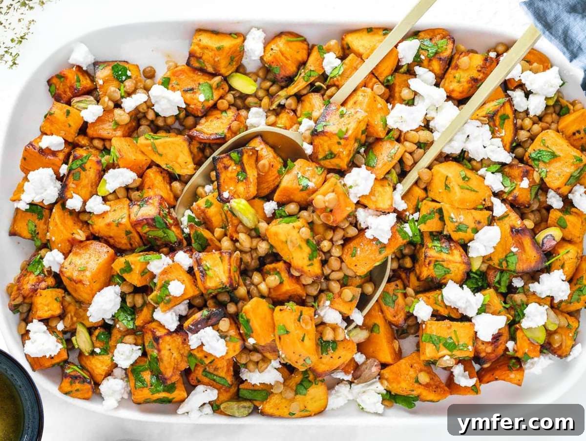 Step 4 Healthy lentil sweet potato salad served on a white platter with parsley garnish.