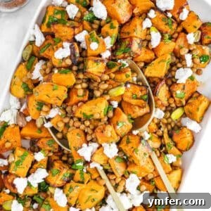 Mediterranean healthy lentil sweet potato salad served in a white bowl with feta.