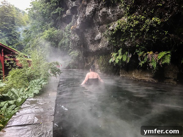 Termas Geometricas Pucon Chile Your Geothermal Escape 3 A serene hot spring pool at Termas Geometricas, surrounded by vibrant green foliage.