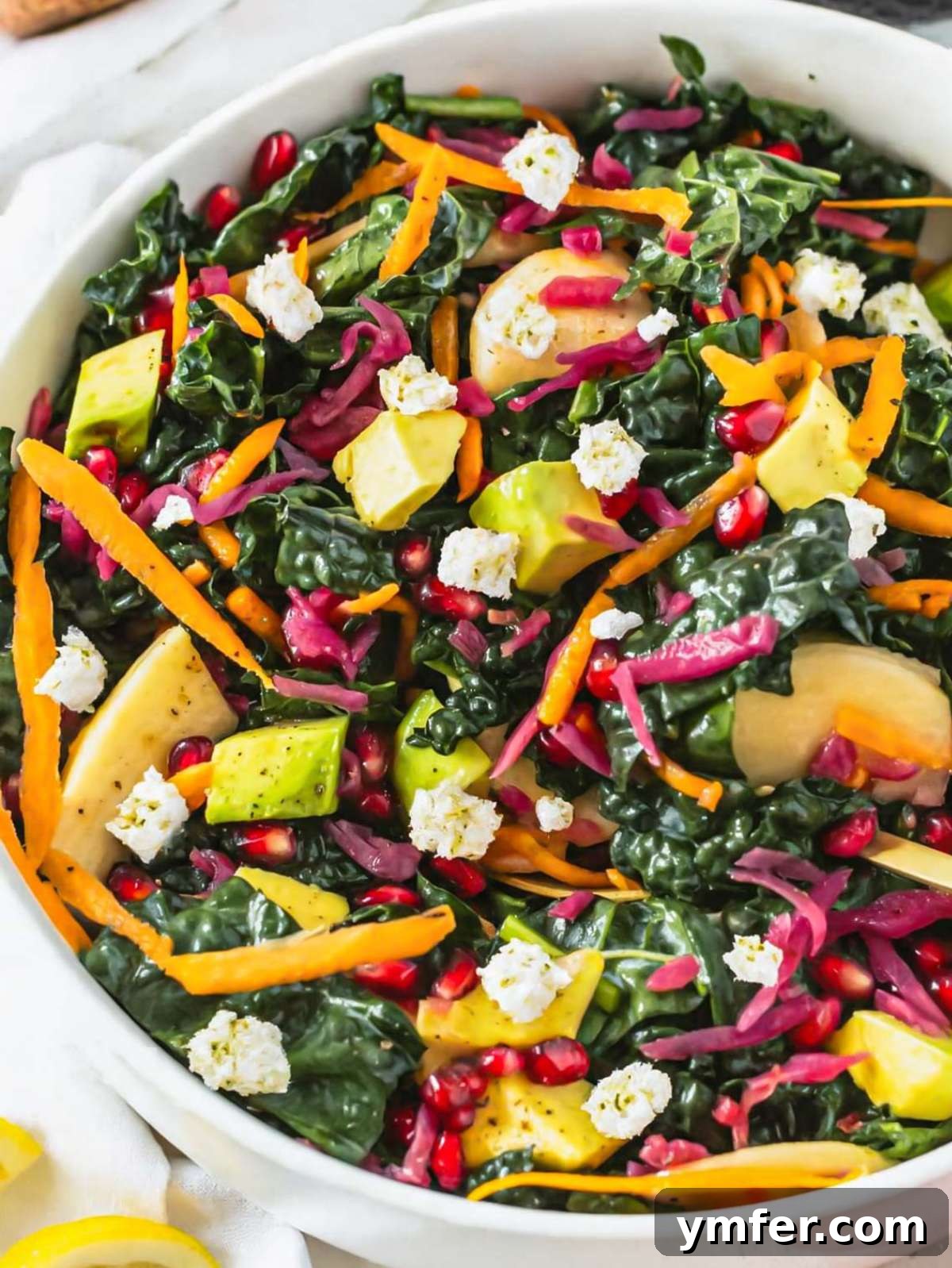Mediterranean Kale Power Salad: Healthy and Fiber-Packed 2 Close up Mediterranean kale salad with feta apple avocado and pomegranate seeds