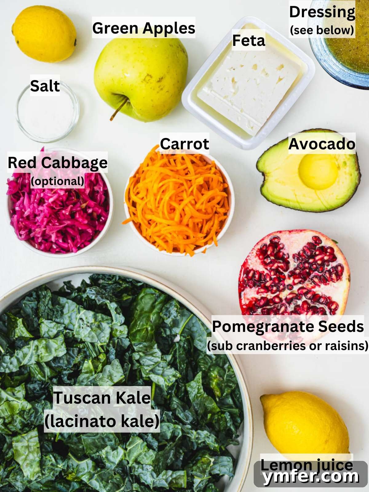 Mediterranean Kale Power Salad: Healthy and Fiber-Packed 3 Fresh kale apple avocado carrot feta cheese and pomegranate seeds on kitchen counter.