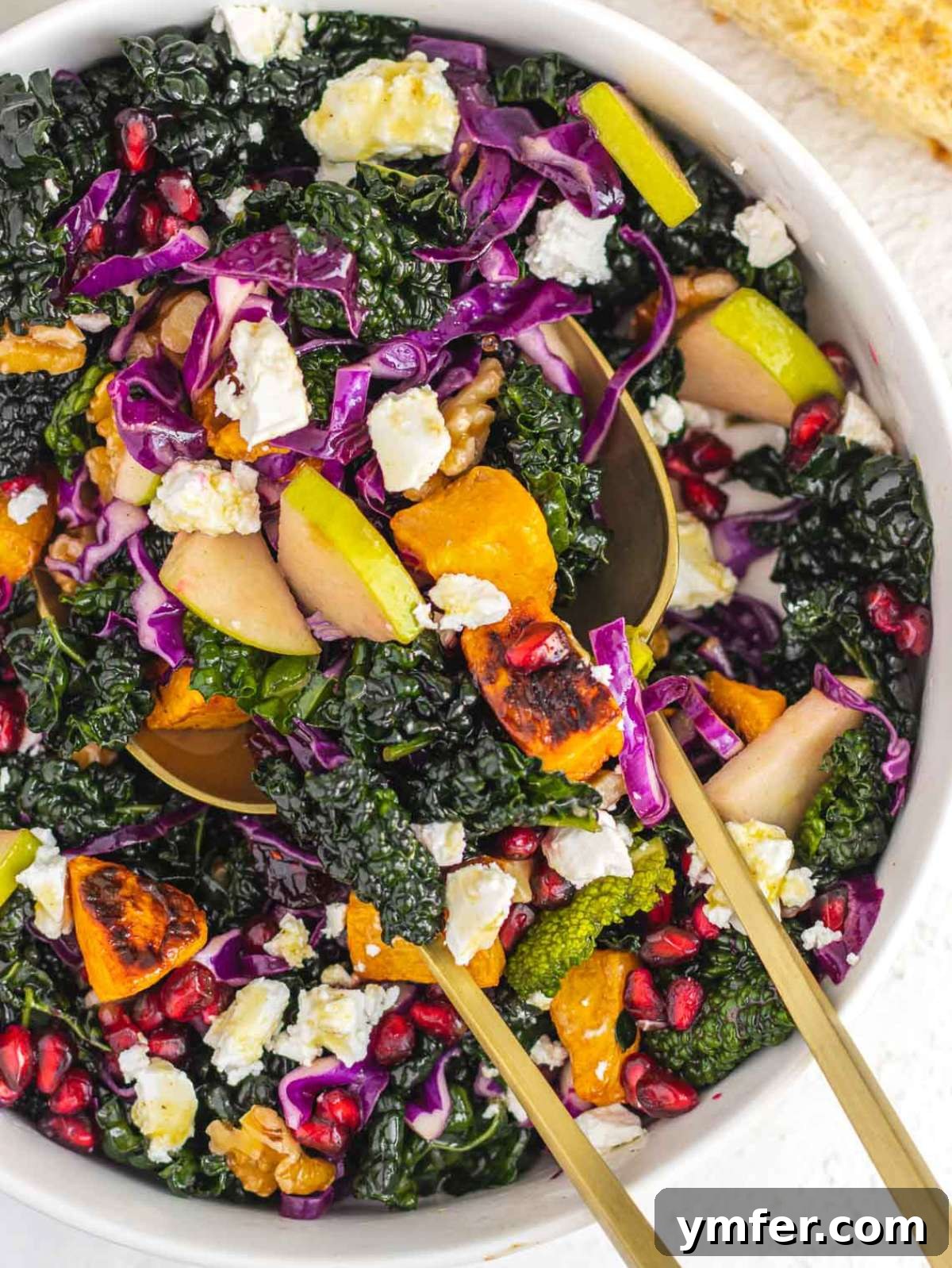 Nourishing Butternut Squash Kale Salad 2 Top down view of colorful butternut squash kale salad with feta walnuts and pomegranate seeds.