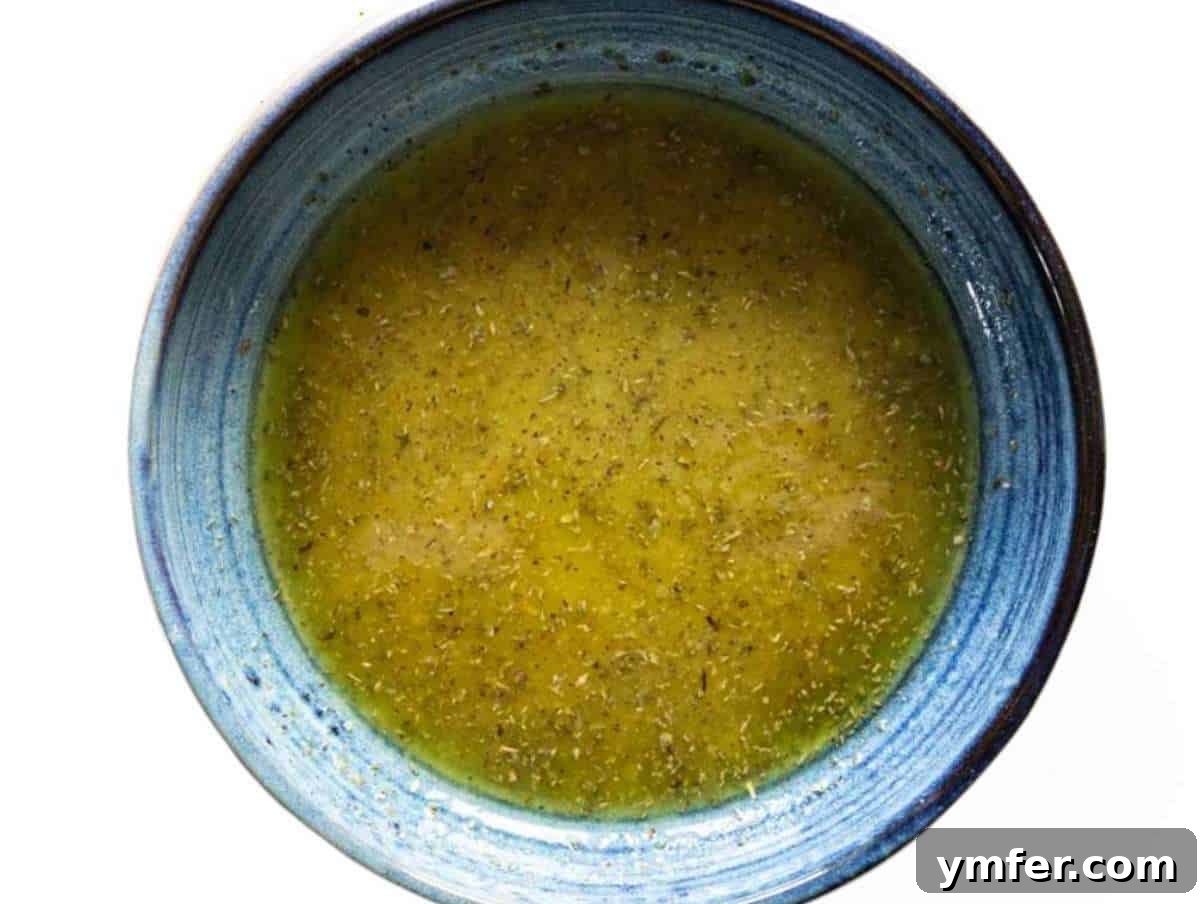 Nourishing Butternut Squash Kale Salad 7 Step 3 Small bowl with honey mustard vinaigrette dressing freshly whisked with olive oil and Dijon mustard.