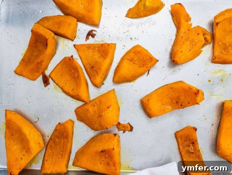 Nourishing Creamy Coconut Pumpkin Soup for Fall 12 Step 2 Roasted pumpkin pieces golden and tender on a baking tray fresh from the oven.
