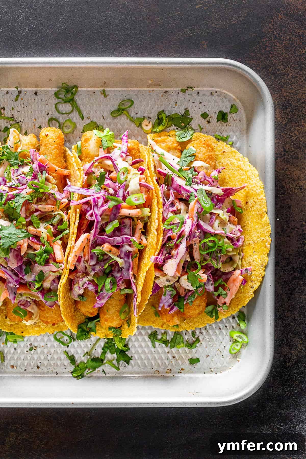 No-Fuss Fish Tacos 2 Easy Fish Tacos on a sheet pan, ready to be assembled.