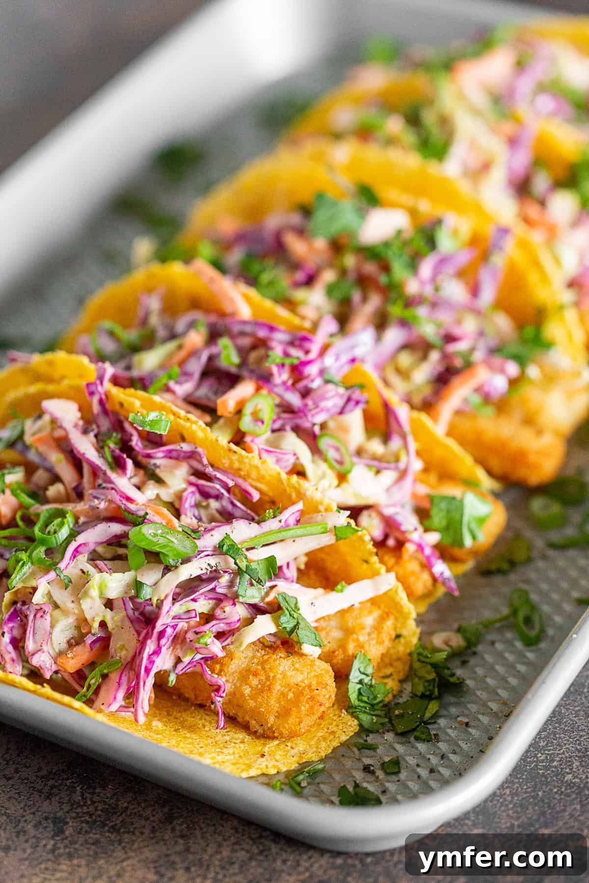 No-Fuss Fish Tacos 5 Easy Fish Tacos topped with fresh Greek yogurt slaw, ready for a delicious meal.