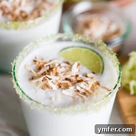 This coconut lime frozen margarita is just what your summer ordered! PACKED full of sweet coconut flavor and jazzed up with zippy lime juice. Instead of salt, I opted to rim the cocktail with lime sugar and top it with toasted coconut.